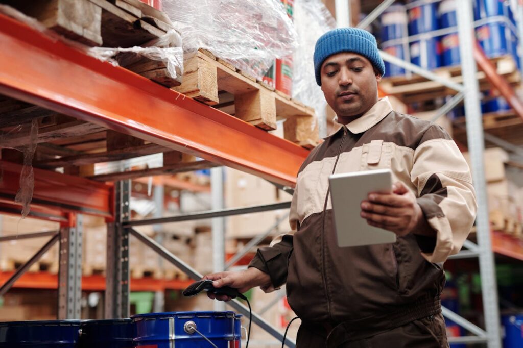 A warehouse employee scans items using a tablet, ensuring inventory accuracy.